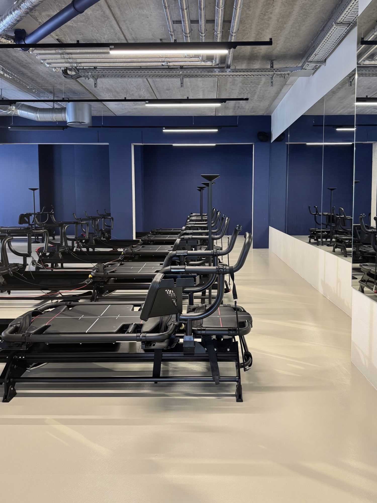 Row of black Megaformers in the blue Some Good Moves training studio.