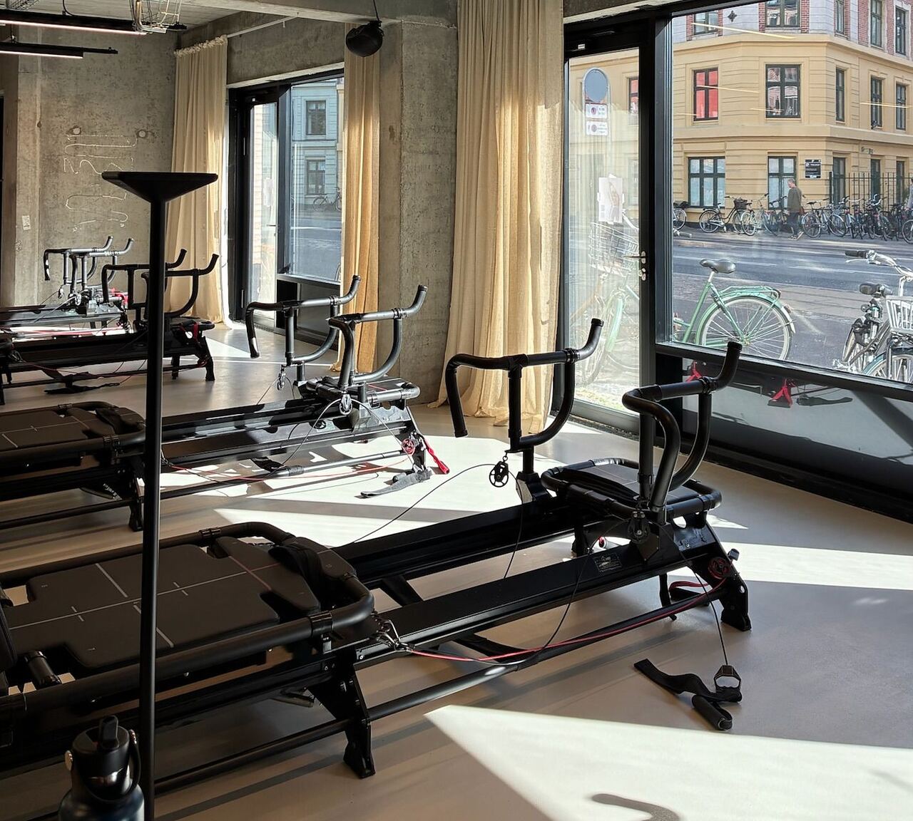 Megaformers lined up along the sunlit windows of the Some Good Moves training floor