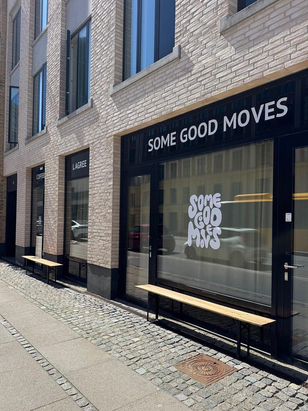The Some Good Moves storefront on Enghavevej with its window logo and benches outside